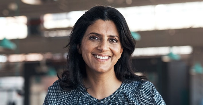 Woman in an office, smiling